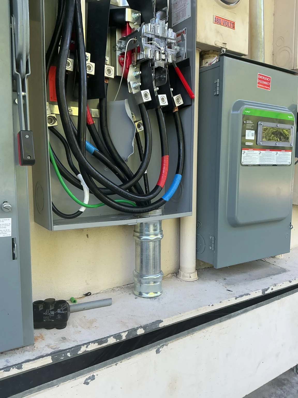 Commercial electrical service equipment with an open enclosure, conductors, and disconnect
